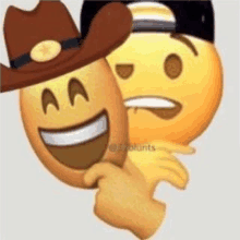 a person wearing a cowboy hat is holding a smiley face behind another smiley face .