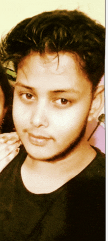 a close up of a young man 's face with a beard