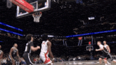 a basketball game is being played in front of a redbull banner