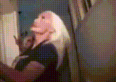 a woman with blonde hair is taking a picture of herself in the mirror