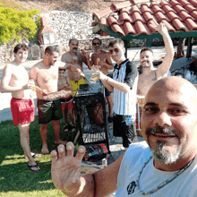 a man with a beard is standing in a group of men