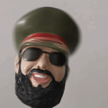 a statue of a man with a beard wearing a military hat and sunglasses