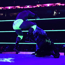 a wrestler wearing glow in the dark shorts that say new