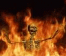 a skeleton is surrounded by flames in a fire .