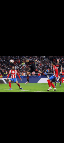 a soccer player is jumping in the air to head the ball during a game