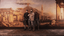 three men are posing in front of a painting of a volcano