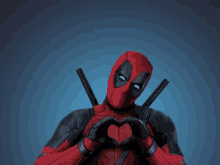 deadpool making a heart shape with his hands on a blue background