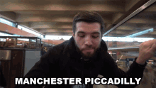 a man says manchester piccadilly while eating