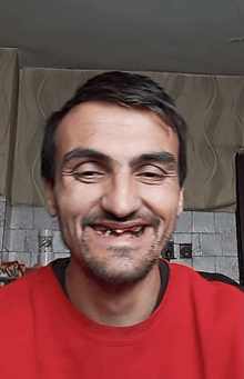 a man wearing a red sweater has a tooth missing