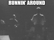 a black and white photo of a man playing a guitar and the words runnin ' around above him