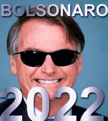 a man wearing sunglasses is smiling in front of the word bolsonaro