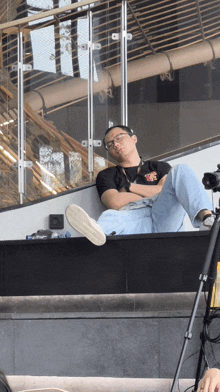 a man laying down with his legs crossed and a t-shirt that says ' i love you ' on the front