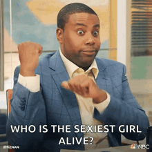 a man in a blue suit and white shirt is asking who is the sexiest girl alive