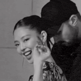 a black and white photo of a man and woman smiling