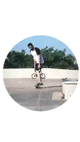 a man is riding a skateboard in a circle with a bicycle in the background