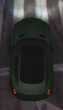 an aerial view of a green sports car on a road