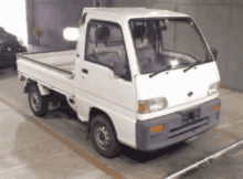 a white truck is parked in a parking lot with a yellow line