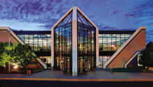 a large building with a lot of windows and stairs leading to it