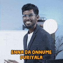 a man with glasses and the name enna da onnume puriyala