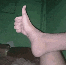 a foot is giving a thumbs up sign