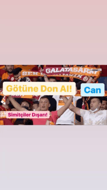 a group of people wearing scarves that say galatasaray and can