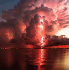 a lightning storm over a body of water at night