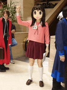 a woman in a cartoon character costume is standing in a hallway with other people .