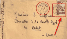 an envelope addressed to s. calvain has a red arrow pointing to it