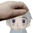 a hand is touching the head of a stuffed toy .