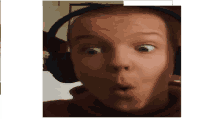 a young man wearing headphones making a surprised face