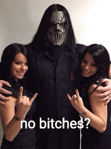 a man in a mask is surrounded by two women with the words no bitches below them