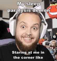 a man with a beard wearing headphones with a caption that says my sleep paralysis demon