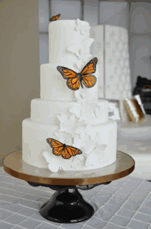 a white cake with three butterflies on top of it