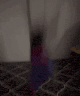 a blurred image of a person standing in a dark room