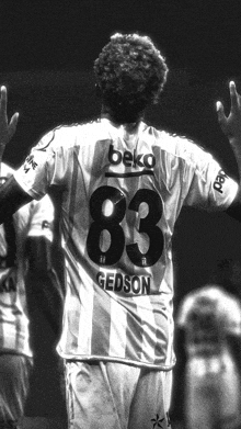 a black and white photo of a soccer player wearing the number 83