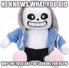 a stuffed animal of sans from undertale is sitting on a white surface .