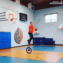 a man is balancing on a unicycle while holding a basketball in a gym that says people are awesome on the bottom