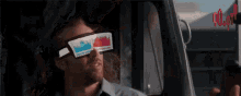 a man wearing a pair of 3d glasses with graphs on them is smiling