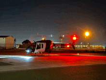 a black and white helicopter with the letters n1mes on the side of it