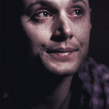 a close up of a man 's face with tears running down his face
