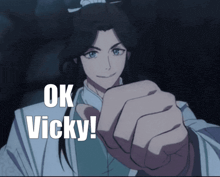 a man with long hair is pointing at the camera with the words ok vicky written below him
