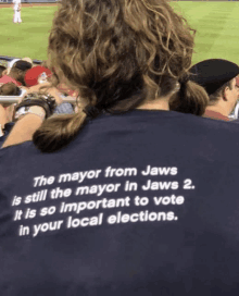 a person wearing a blue shirt that says the mayor from jaws is still the mayor in jaws 2