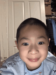 a little boy wearing a blue shirt with airplanes on it