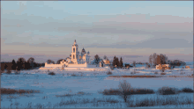 a snowy field with a church in the distance