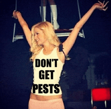 a woman wearing a tank top that says " don 't get pests "