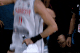 a basketball player wearing a number 21 jersey