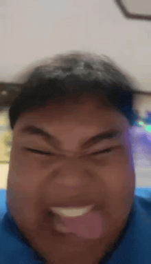 a close up of a person making a funny face with their tongue out