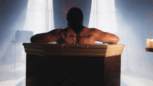 a man in a bathtub with barbed wire tattoo on his back
