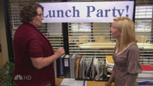 two women are standing in front of a lunch party sign