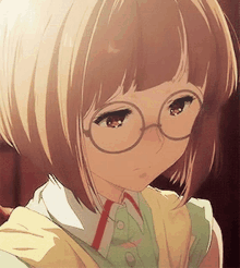 a girl with short hair and glasses is looking down .